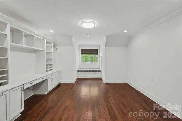 a view of a room with wooden floor and window