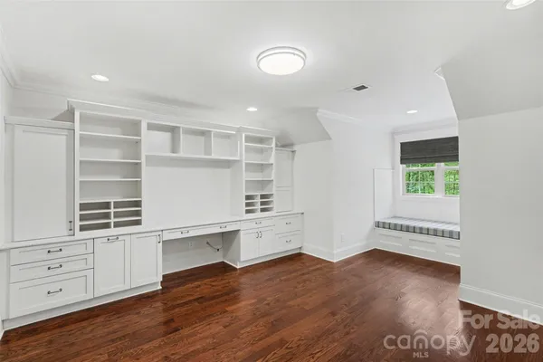 wooden floor with white cabinets and wooden floor
