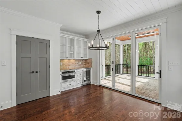a view of a room with wooden floor fireplace and windows
