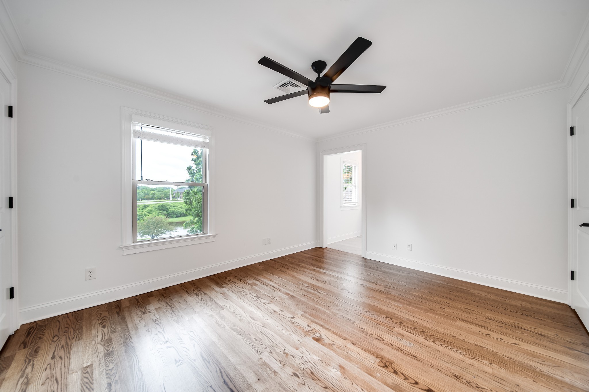 116 Foxcross Road Hendersonville, TN 37075 - Photo 42 of 57 an empty room with wooden floor fan and windows