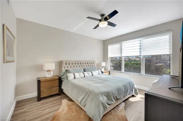 a bedroom with a large bed and a large window