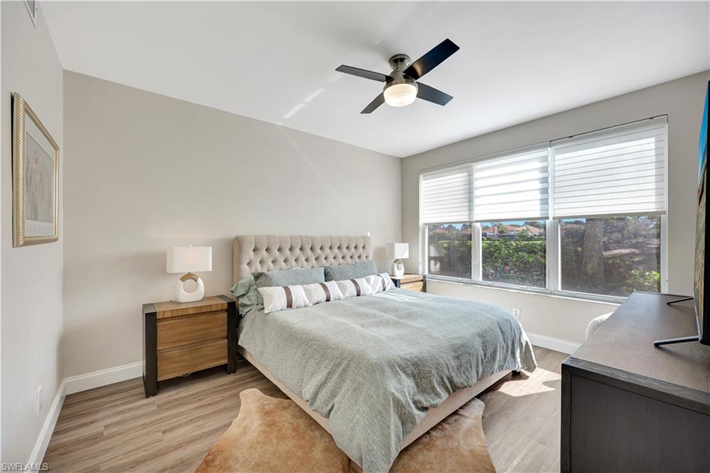 9020 Spring Run Boulevard, Unit 604 Estero, FL 34135 - Photo 14 of 24 a bedroom with a large bed and a large window