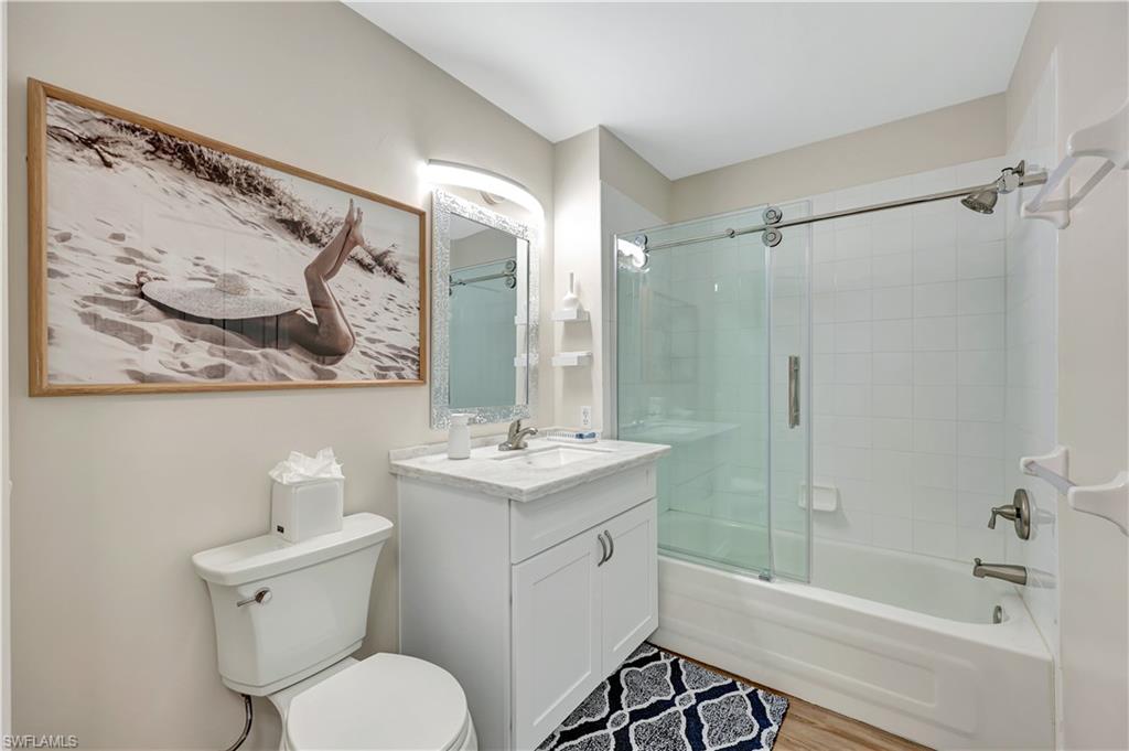 9020 Spring Run Boulevard, Unit 604 Estero, FL 34135 - Photo 18 of 24 a bathroom with a toilet sink and mirror