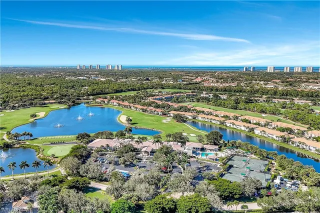 an aerial view of residential building and lake