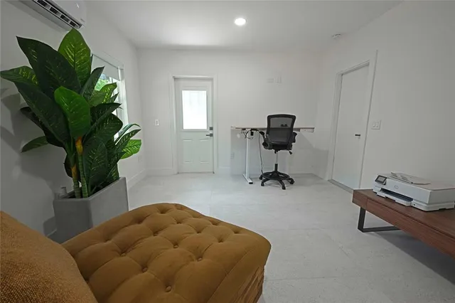 a workspace with furniture and a potted plant