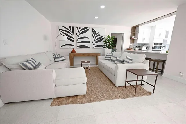 a living room with furniture and a large mirror