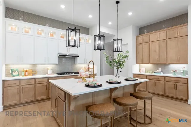 a kitchen with stainless steel appliances kitchen island granite countertop a sink and cabinets