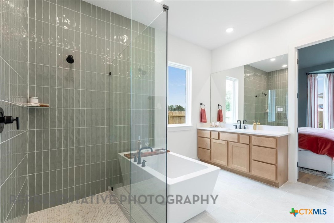 315 Leaning Rock Ridge Austin, TX 78737 - Photo 22 of 40 a bathroom with a tub sink and mirror