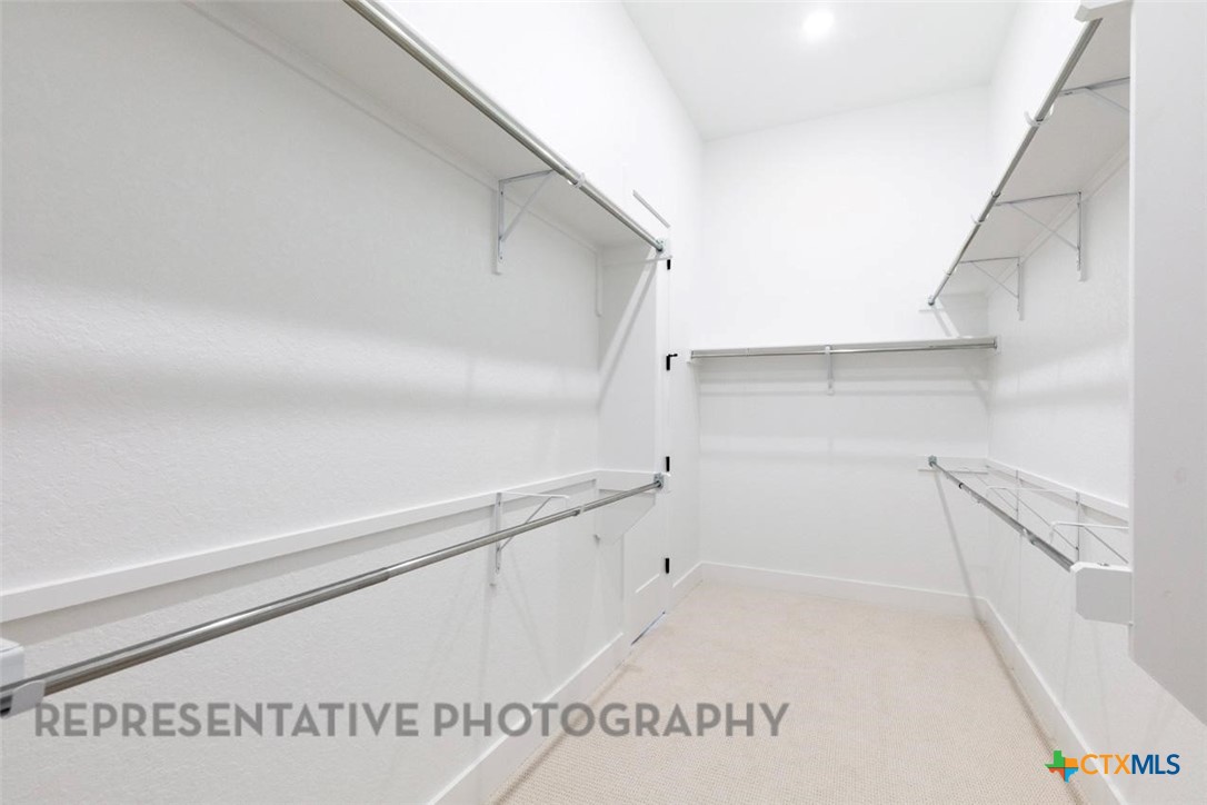 315 Leaning Rock Ridge Austin, TX 78737 - Photo 24 of 40 a view of a kitchen with white cabinets and a window