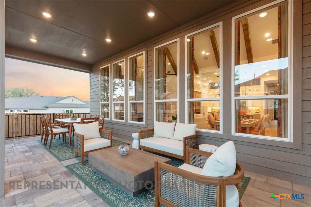 315 Leaning Rock Ridge Austin, TX 78737 - Photo 32 of 40 a living room with furniture and a floor to ceiling window