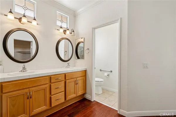 a bathroom with a granite countertop toilet sink and mirror