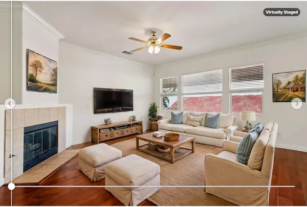 a living room with furniture a flat screen tv and a fireplace