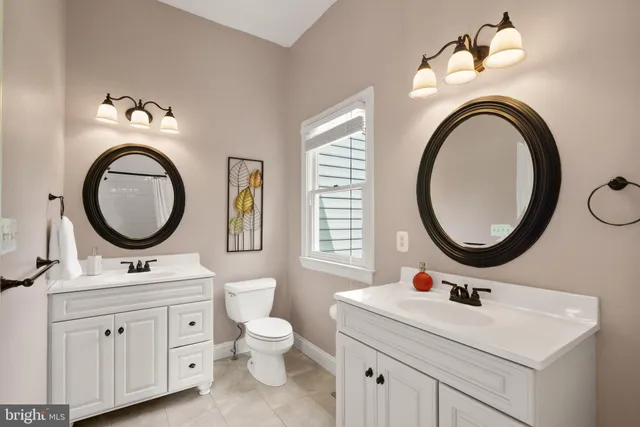 a white toilet sitting next to a bathroom sink