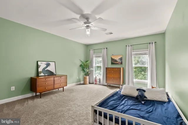 an aerial view of residential houses with outdoor space and trees