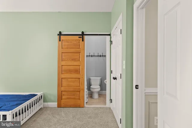 an aerial view of a houses with a lush green hillside