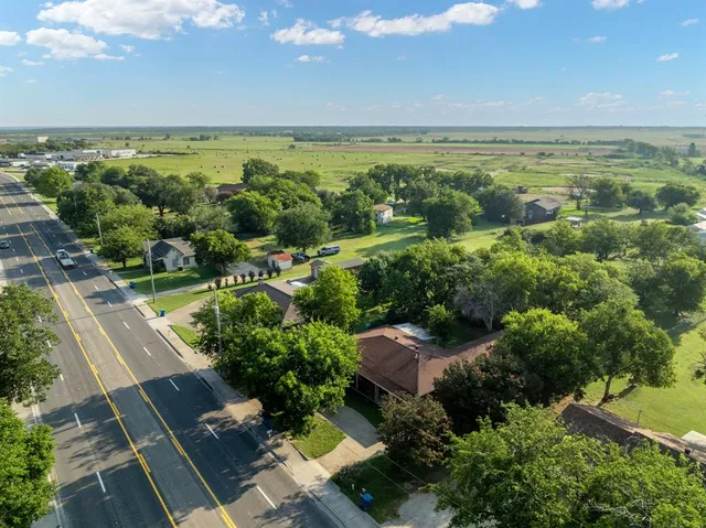 an aerial view of a houses with a yard