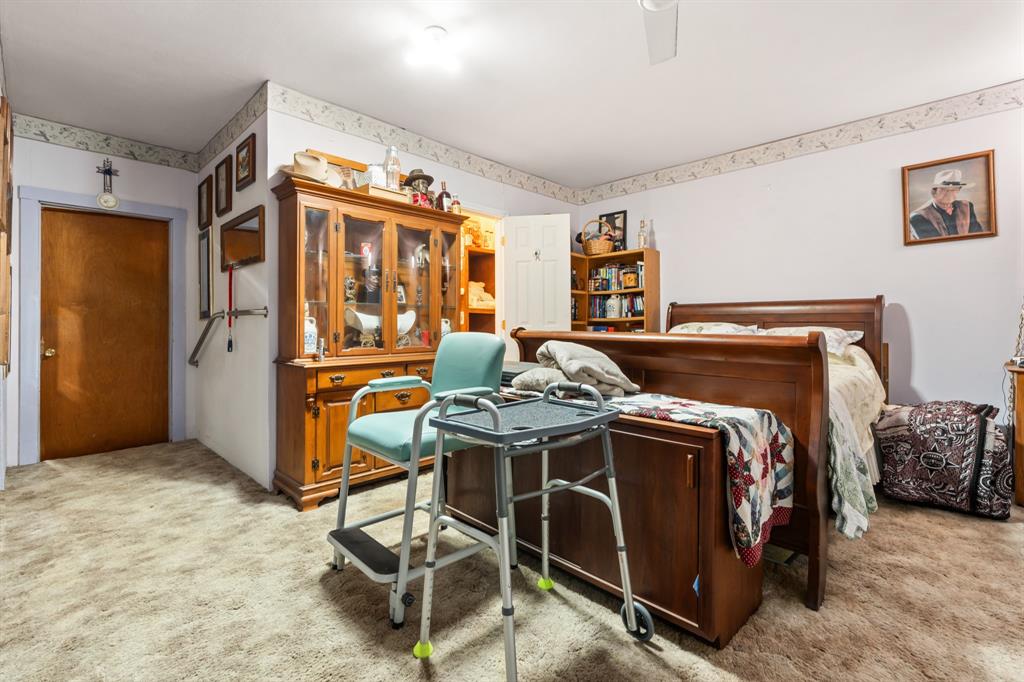 802 North Brazos Street Whitney, TX 76692 - Photo 14 of 33 a bedroom with a bed and a table in it