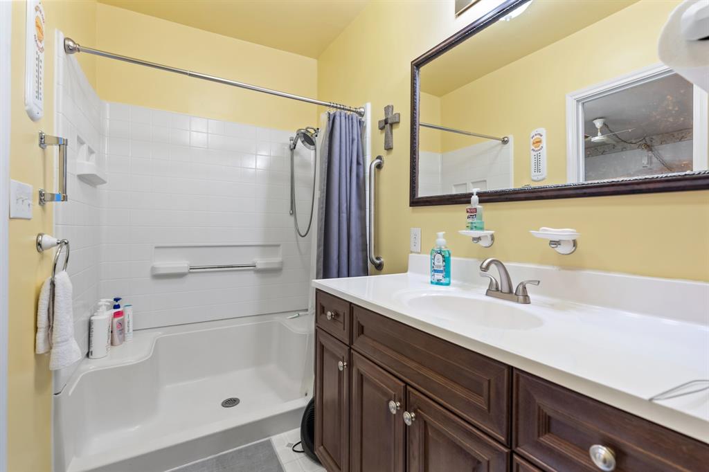 802 North Brazos Street Whitney, TX 76692 - Photo 16 of 33 a bathroom with a sink and a mirror