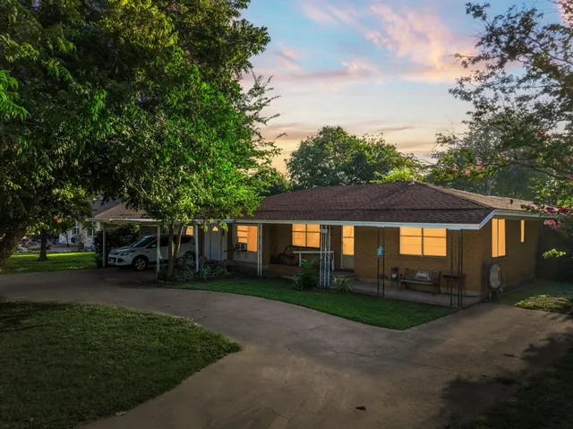 a front view of house with yard and green space