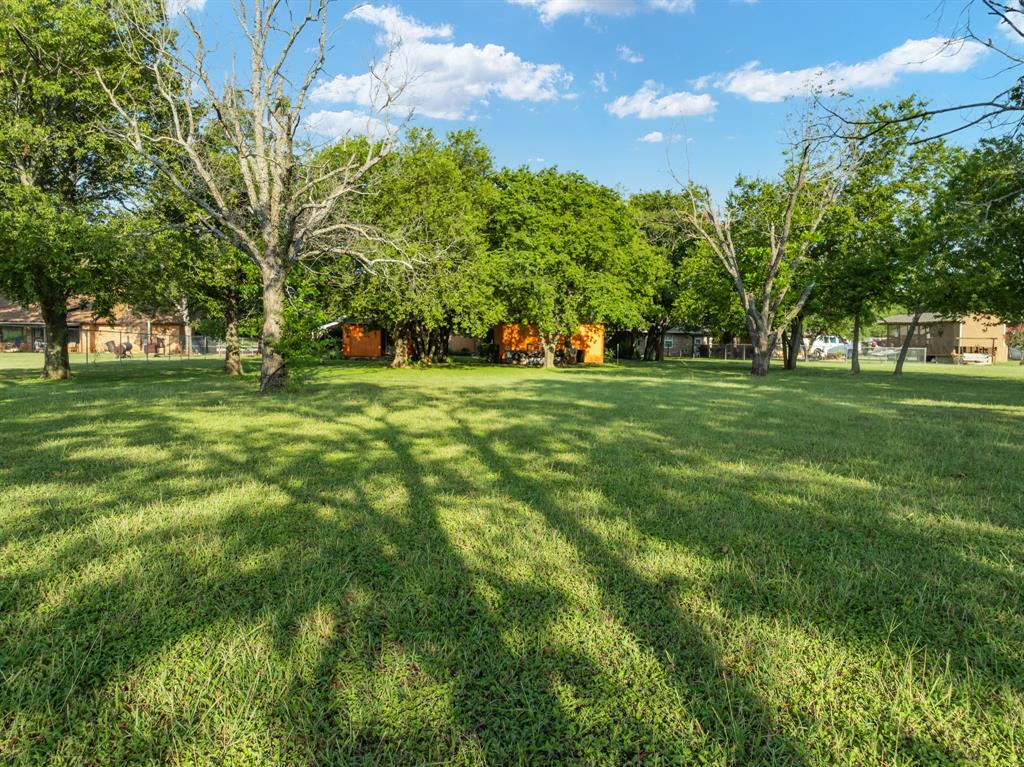 802 North Brazos Street Whitney, TX 76692 - Photo 26 of 33 a big yard with lots of green space and trees