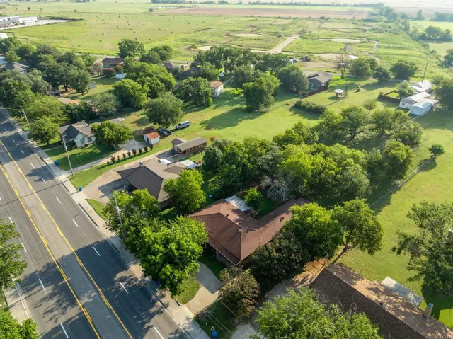 an aerial view of residential houses with outdoor space and swimming pool