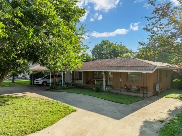 a view of a house with a backyard porch and sitting area