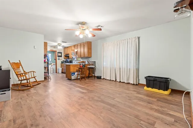 a view of a livingroom with furniture and a ceiling fan
