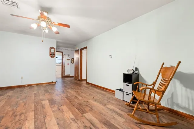 a view of a room with wooden floor and gym equipment