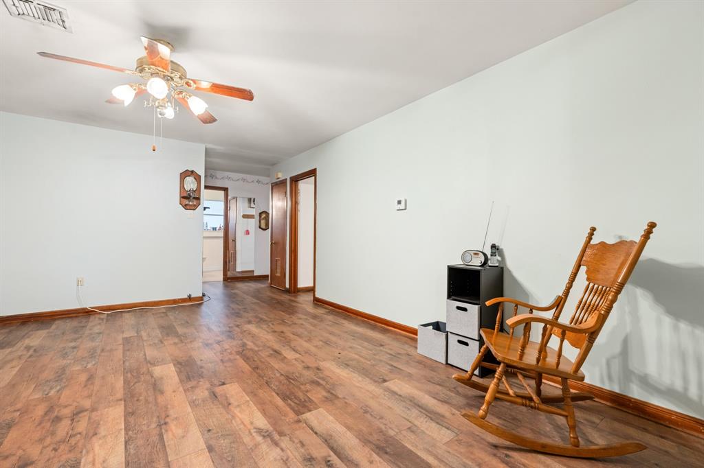 802 North Brazos Street Whitney, TX 76692 - Photo 9 of 33 a view of a room with wooden floor and gym equipment