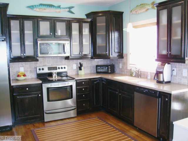 Kitchen. Tile Backsplash, stainless appliances & solid surface tops