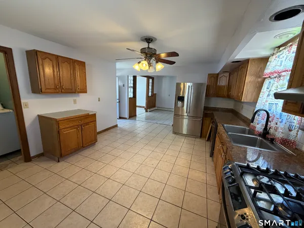 a kitchen with stainless steel appliances a stove a refrigerator and a sink