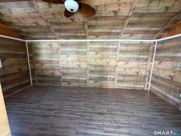 a room with water heater and wooden floor