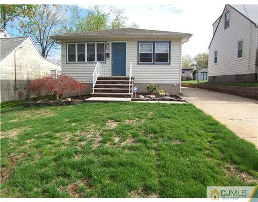 72 Middle Hill Road Colonia, NJ 07067 - Photo 1 of 17 a front view of a house with a garden