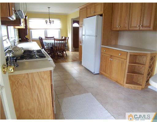 72 Middle Hill Road Colonia, NJ 07067 - Photo 6 of 17 a kitchen with stainless steel appliances granite countertop a refrigerator a stove and a sink