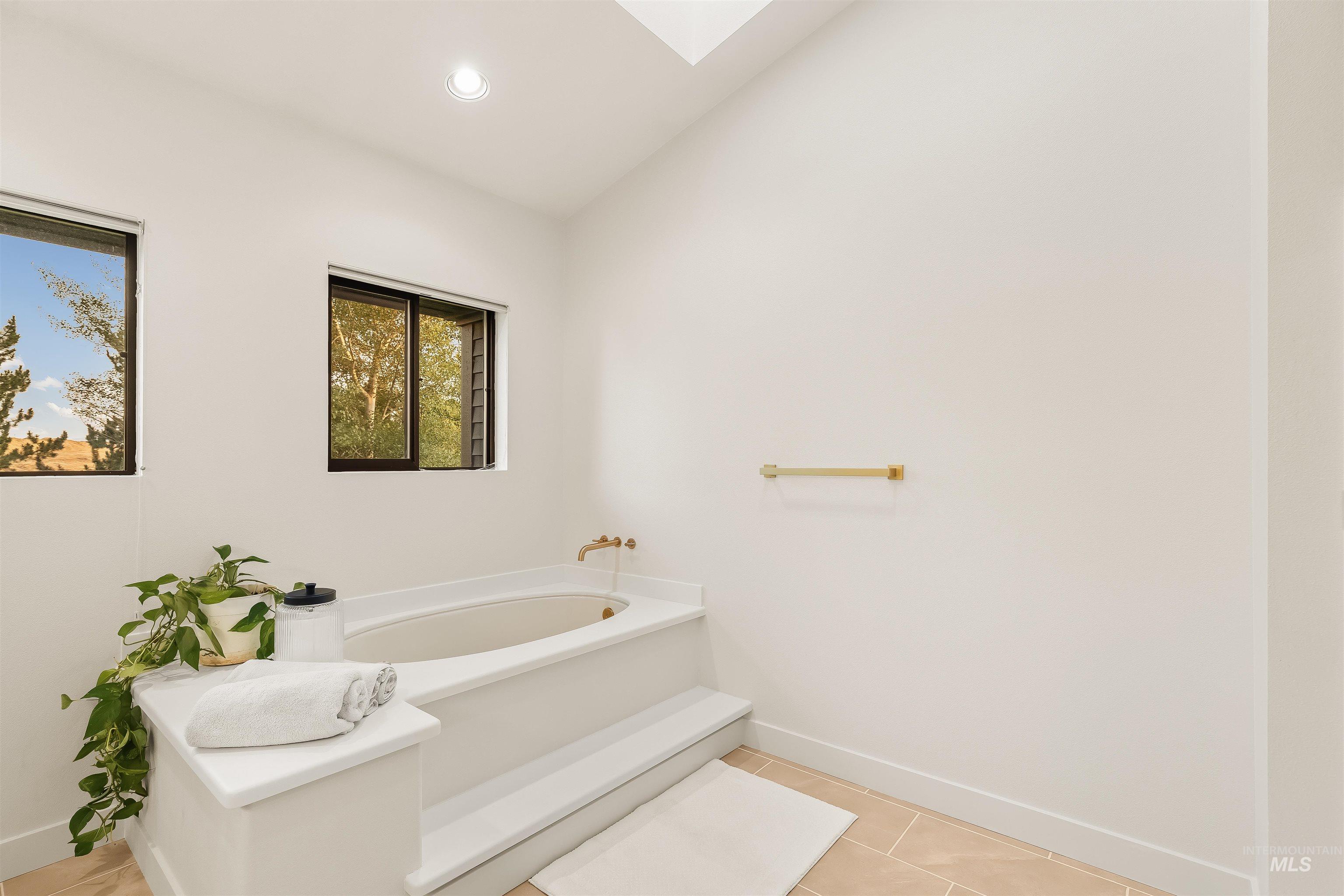 2048 Arborcrest Road Moscow, ID 83843 - Photo 30 of 50 Soaking tub with a built-in surround, dual windows, and recessed lighting