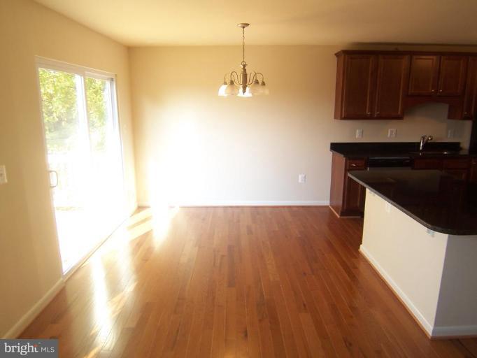 7909 Hart Road Fort Washington, MD 20744 - Photo 7 of 21 a kitchen with a sink and wooden floor