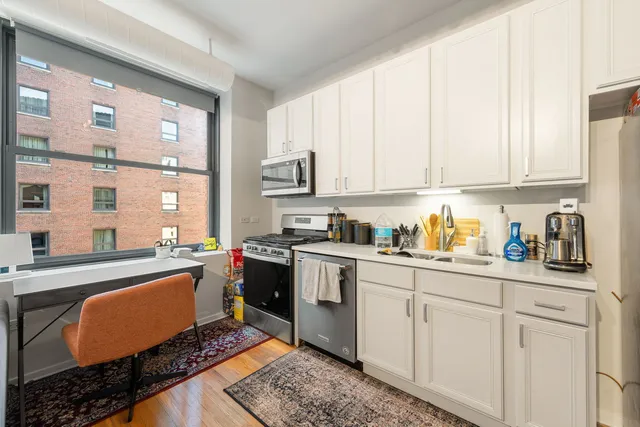 a kitchen with stainless steel appliances granite countertop a stove a sink and a granite counter tops
