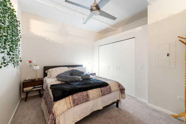 a bedroom with a bed and a potted plant