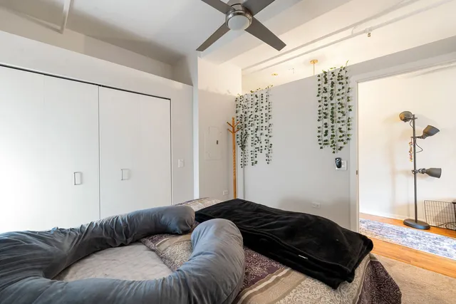 a bedroom with a bed window and couch