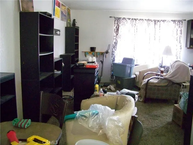 a living room with furniture closet and a window