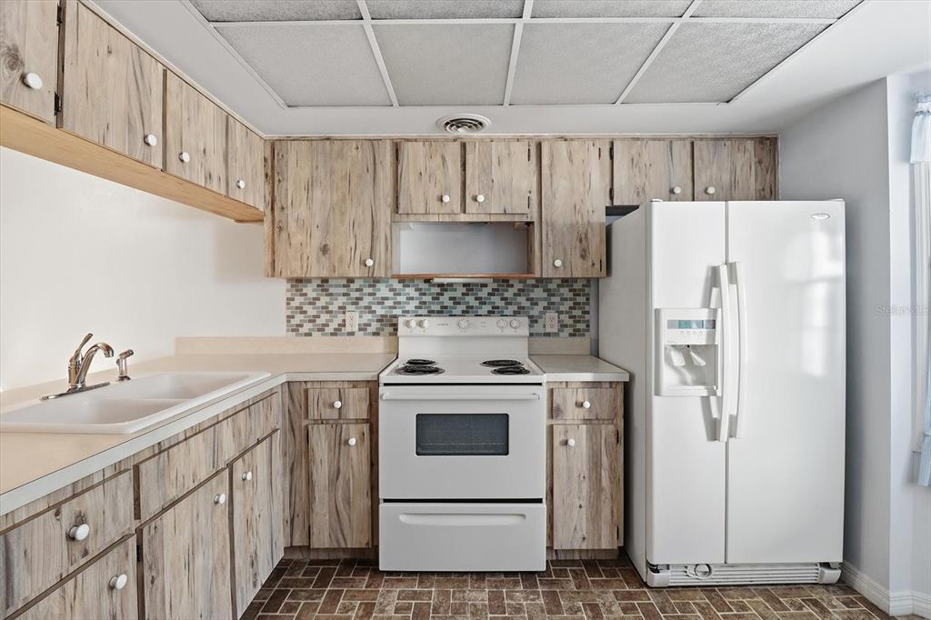 3966 North Spanish Moss Point Beverly Hills, FL 34465 - Photo 10 of 39 a kitchen with a white cabinets stove and refrigerator