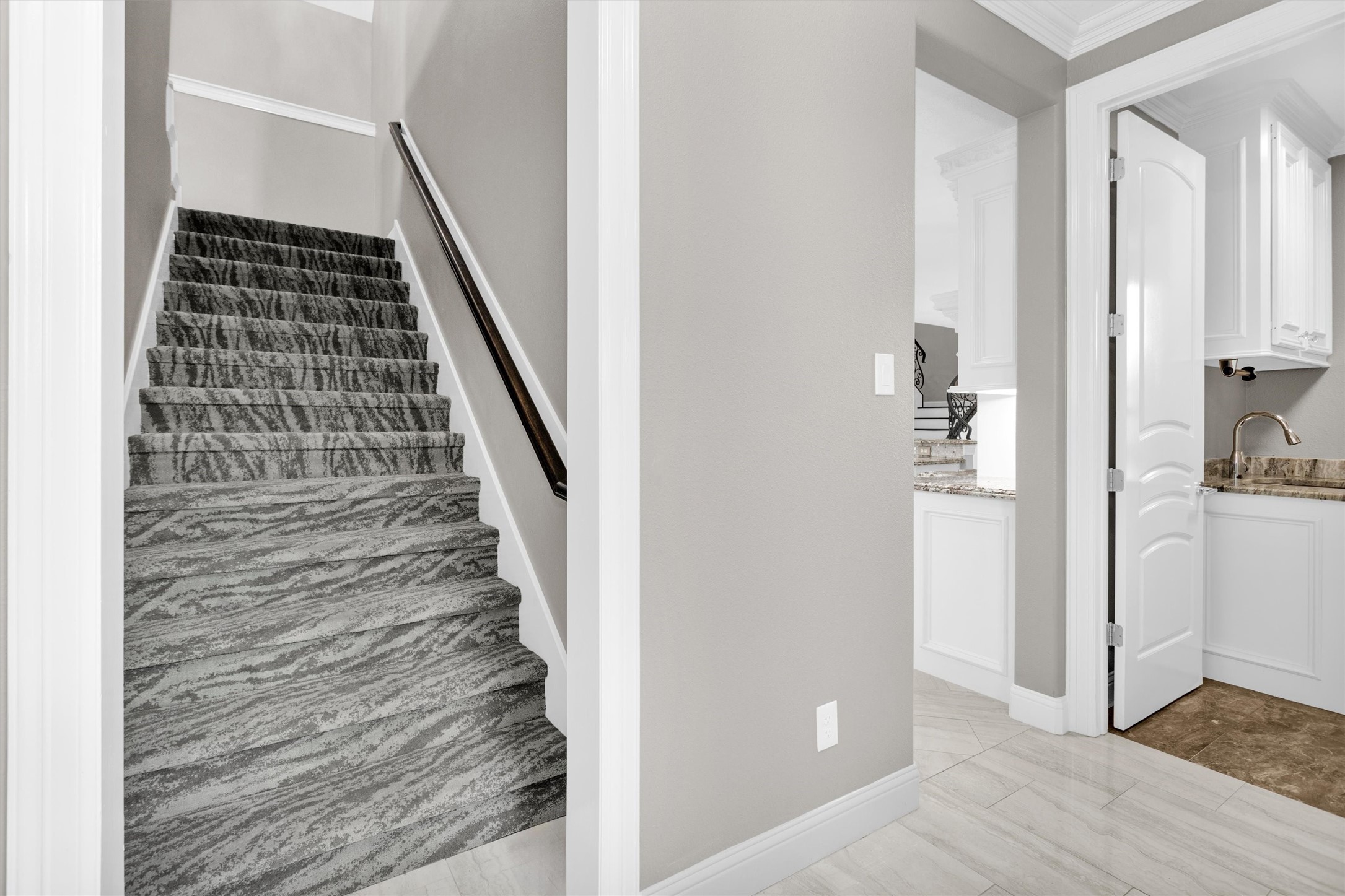 10887 Decatur Street Willis, TX 77318 - Photo 41 of 50 Private staircase tucked just off the kitchen and utility room (complete with a half-bath, built-in cabinetry & a sink) leads to a separate upstairs living space featuring a massive gameroom, ideal for entertaining or a dedicated retreat.