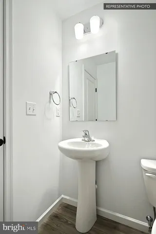 a bathroom with a sink toilet and mirror