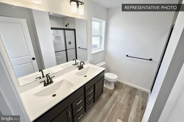 a bathroom with a sink a toilet and mirror