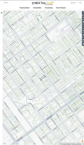 a white wall with shower and a wooden floor