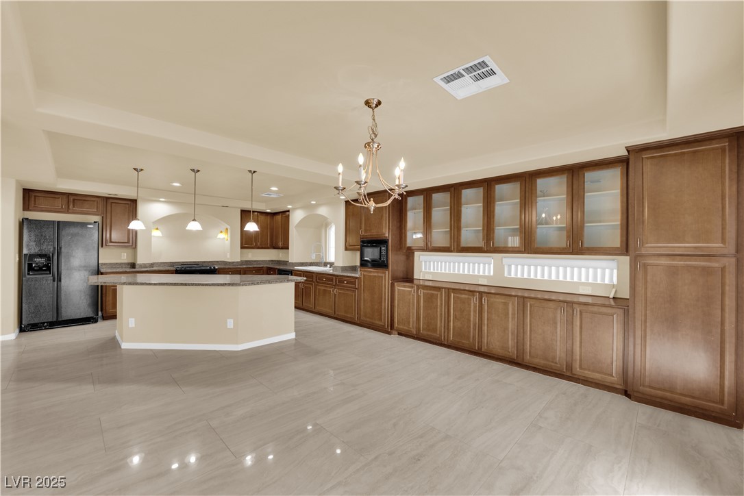 1142 Sax Fifth Avenue Henderson, NV 89052 - Photo 11 of 44 Spacious open kitchen with expansive granite counters, pendant lighting, and wall-to-wall cabinetry.