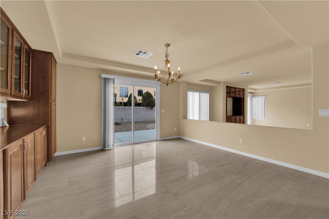 1142 Sax Fifth Avenue Henderson, NV 89052 - Photo 13 of 44 Large dining space with sliding glass doors leading to the backyard—perfect for indoor/outdoor living.