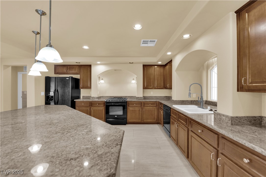 1142 Sax Fifth Avenue Henderson, NV 89052 - Photo 15 of 44 Beautiful granite countertops, arched window framing the sink, and abundant cabinet space.
