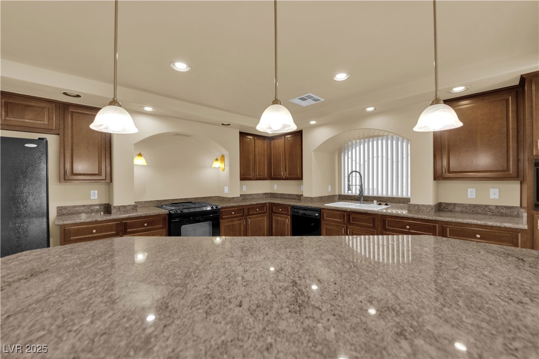 1142 Sax Fifth Avenue Henderson, NV 89052 - Photo 16 of 44 Large center island with pendant lighting—ideal for meal prep, serving, or casual dining.