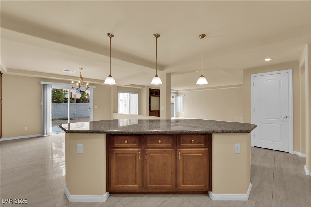 1142 Sax Fifth Avenue Henderson, NV 89052 - Photo 19 of 44 Oversized island with additional cabinetry and stylish pendant lighting overhead.